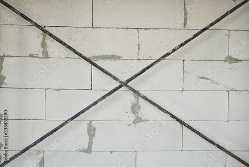 Valokuva iron cross reinforce and white lightweight concrete wall background