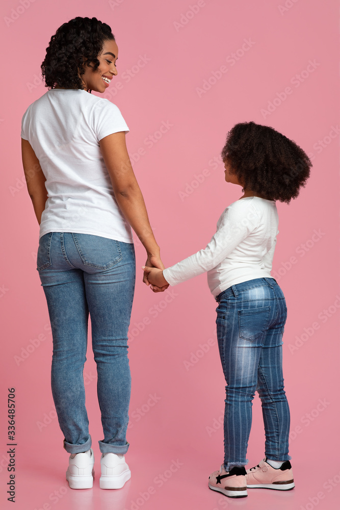 Loving Black Mom And Daughter Holding Hands And Smiling, Rear View Loving Black Mom And Daughter Holding Hands And Smiling, Rear View