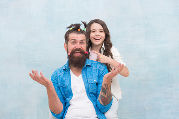 Having fun. happy family day. small girl play with dad. bearded man father having fun with kid. childrens day. love and trust. daughter and father with funny hairdo. hairdresser and barbershop