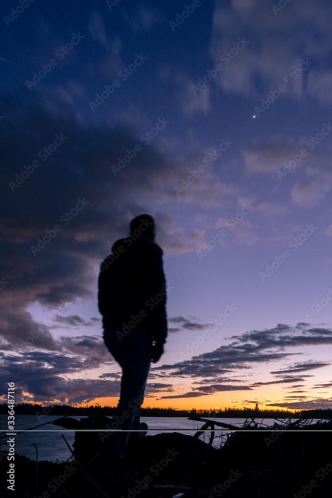 silhouette of a man standing on a rock