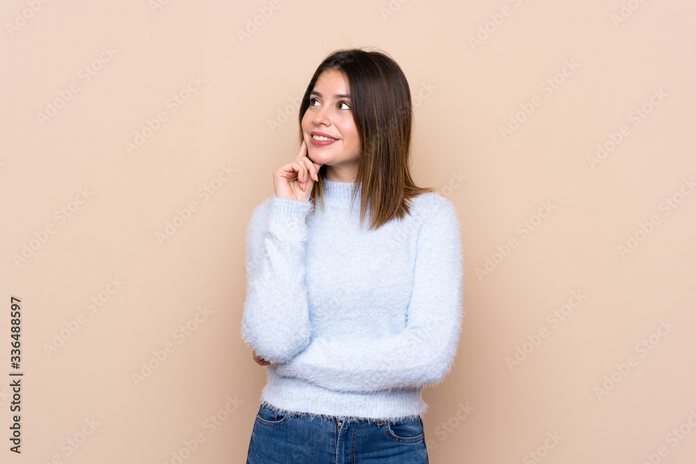 Young woman over isolated background thinking an idea while looking up Young woman over isolated background thinking an idea while looking up