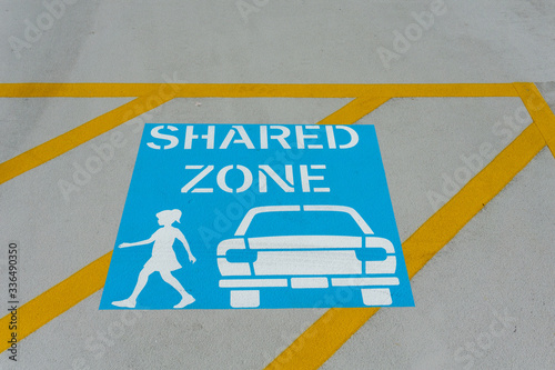 Car and people shared zone sign on ground