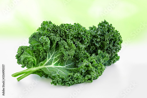 Fresh Kale salad.  Green Kale curly leaves over abstract summer background.  Food concept.