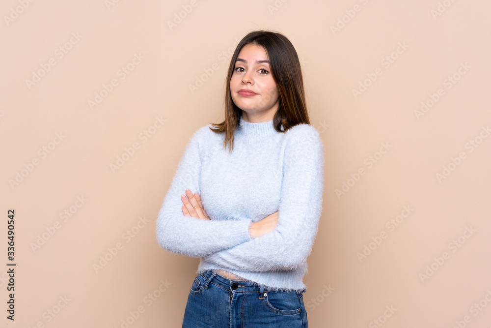 Young woman over isolated background making doubts gesture while lifting the shoulders Young woman over isolated background making doubts gesture while lifting the shoulders