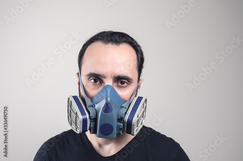 man in a professional protective mask. mask with replaceable filters, used  protection of human respiratory organs © Alex Desanshe