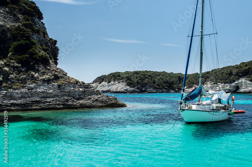 Anchored sailboat in a calm bay in summer day vacation  Mediterranean  Bonifacio  Corsica  France  Europe