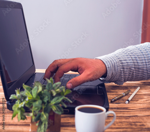  man hand typing on laptop keyboard