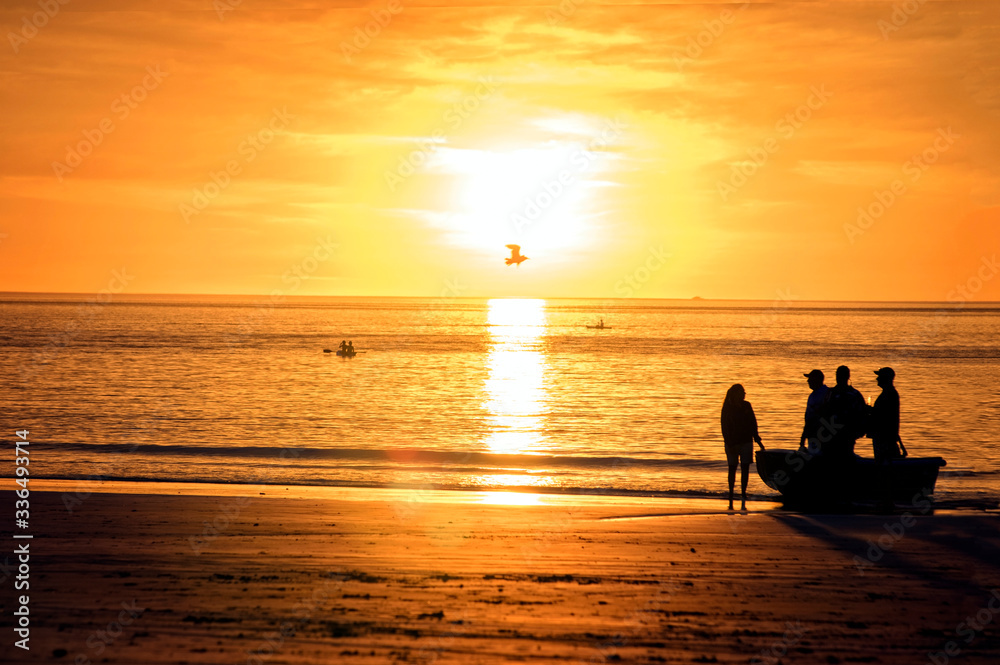 Western Australia – Silhouette of people standing at a boat at the sunset on Cable Beach in Broome