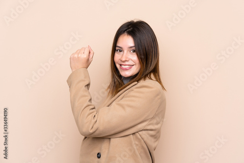 Young woman over isolated background making strong gesture