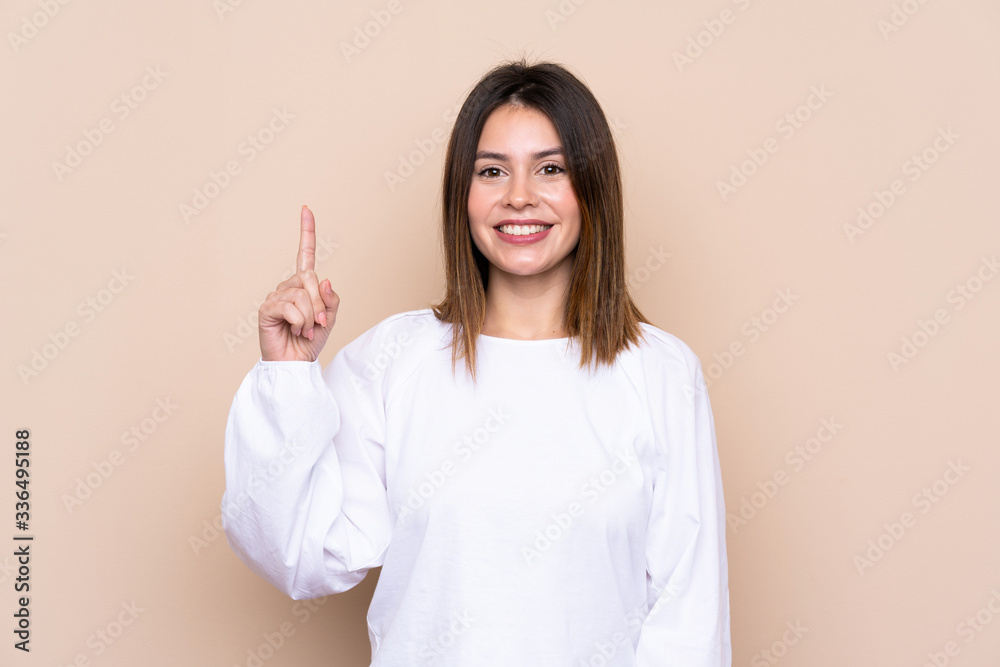 Young woman over isolated background pointing with the index finger a great idea Young woman over isolated background pointing with the index finger a great idea