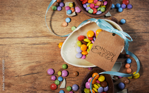 Colorful Easter candies on a rustic wood background