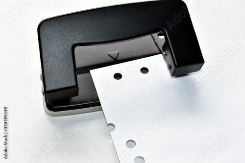 Office black hole punch on white paper