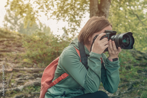 Female hiker photographing nature landscape