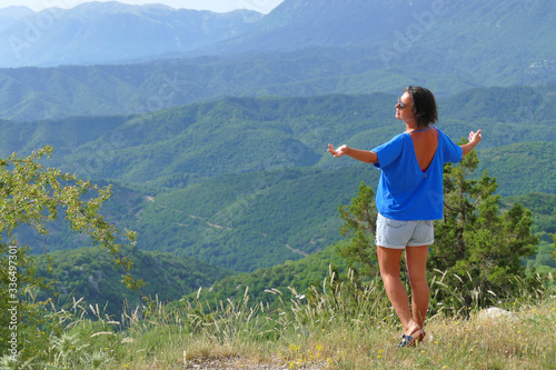 A tourist admire the mountain of Monodendri in Epirus photo