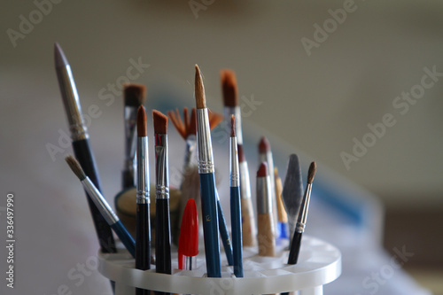 Composition of brushes and pens in a container