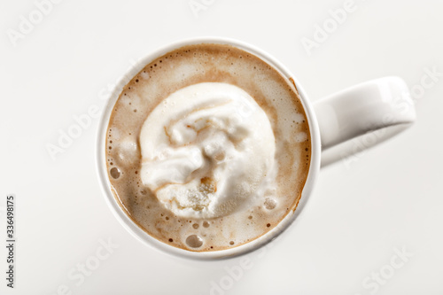 Top view of sweet frappuccino coffee with vanilla ice cream in white ceramic mug. White background. Highest quality of coffee ground. Content for coffee addicted guys