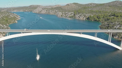 Aerial view of highway bridge over the sea ocean with car. Daily urban working traffic. Yacht sail the canal, beautiful mountain landscape. photo