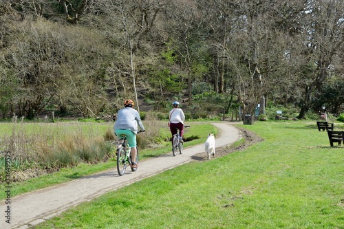 BARRY, VALE OF GLAMORGAN / WALES - APRIL 15 2020: elderly people take daily exercise in the sunshine during the COVID_19 lockdown making sure they are complying with social distance rules
