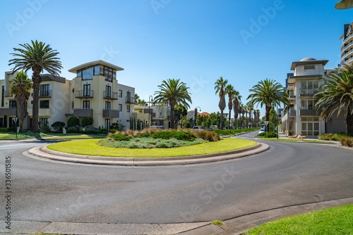 Roundabout and palm tree lined residential roads in modern seaside suburb and homes in Melbourne