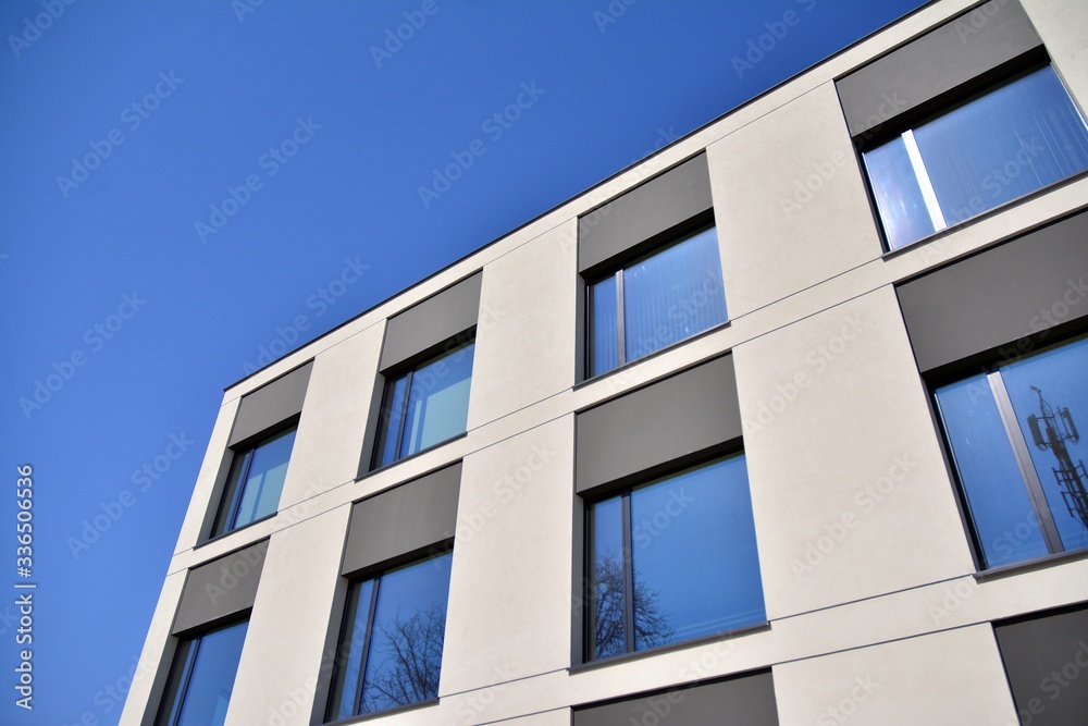 Abstract image of looking up at modern glass and concrete building. Architectural exterior detail of office building. Abstract image of looking up at modern glass and concrete building. Architectural exterior detail of office building.
