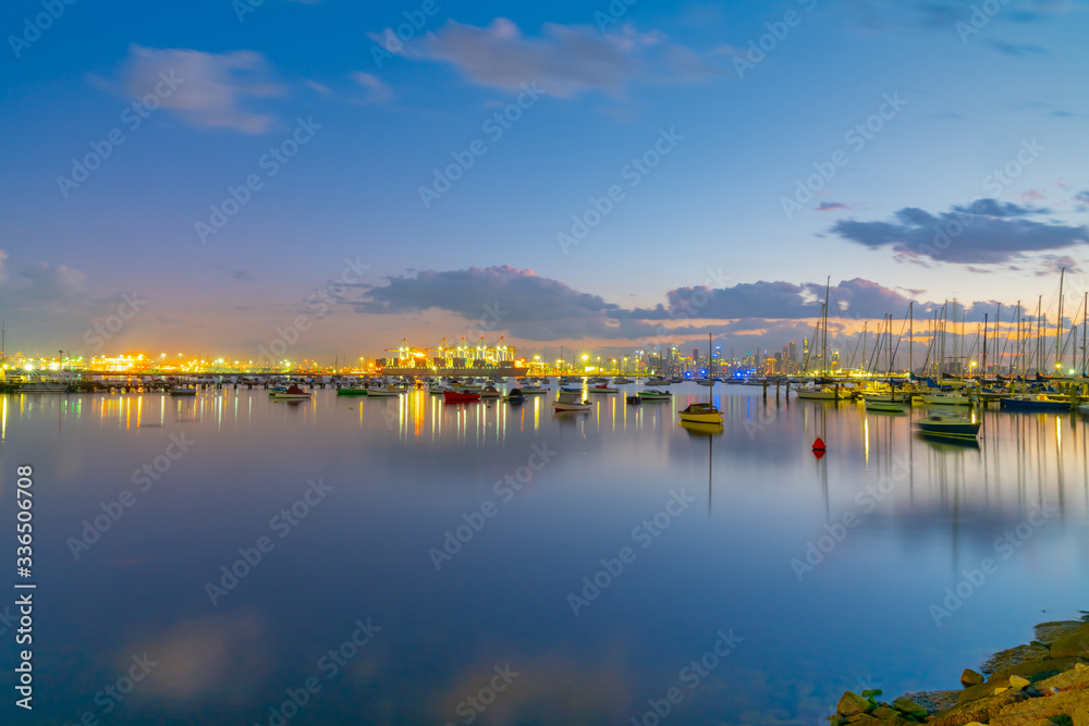 Sunrise over waterfront and boats