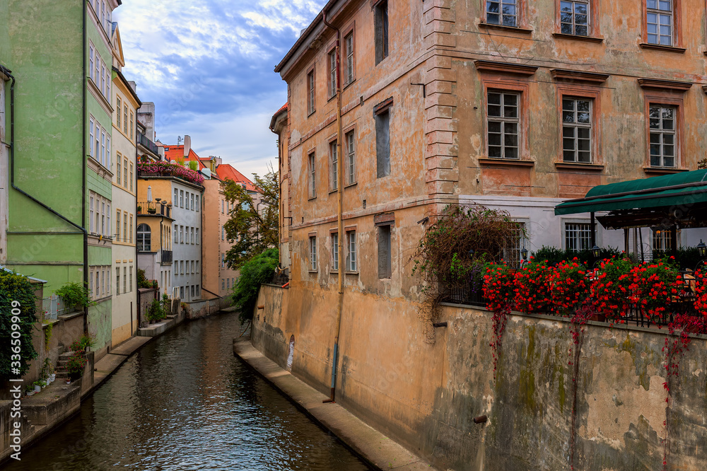 Narrow canal among old houses in Prague, Czechia.