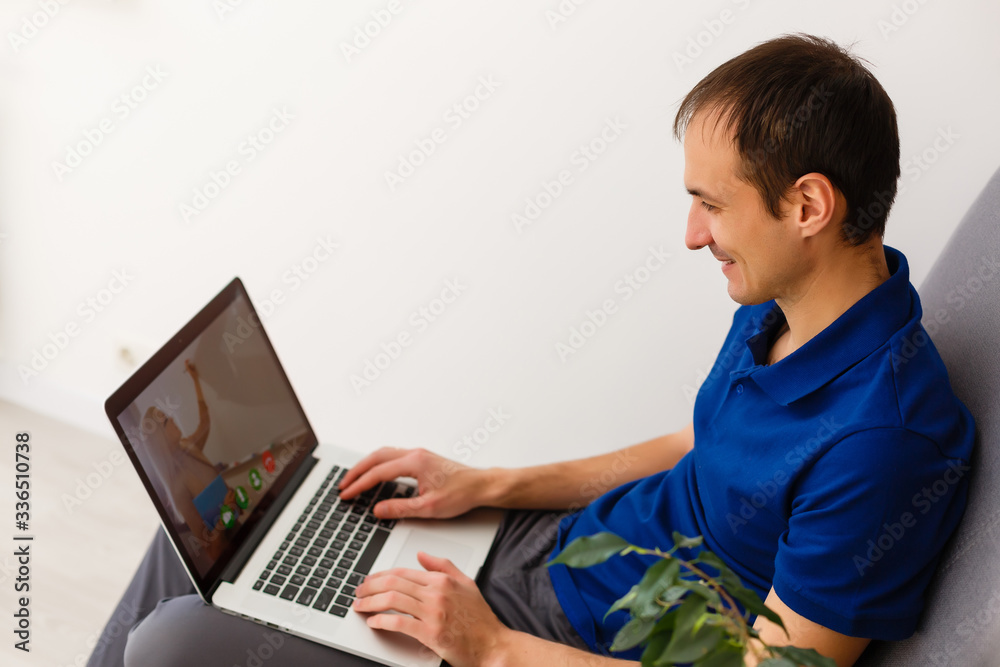 Young man working absorbed on laptop at home copy space Young man working absorbed on laptop at home copy space