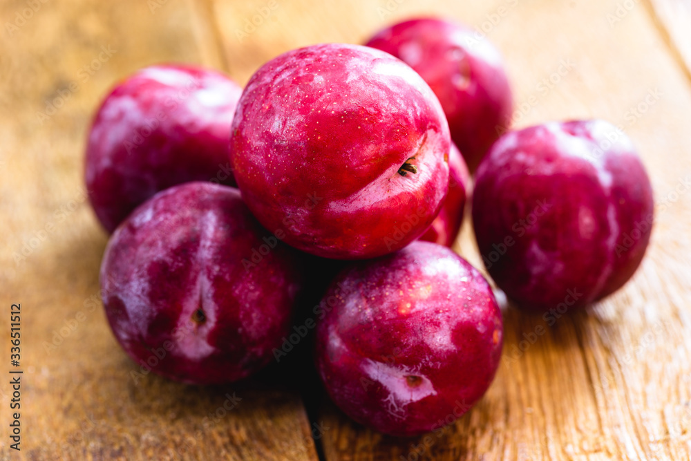Brazilian plum on rustic wooden background, image of tropical fruit. Brazilian plum on rustic wooden background, image of tropical fruit.