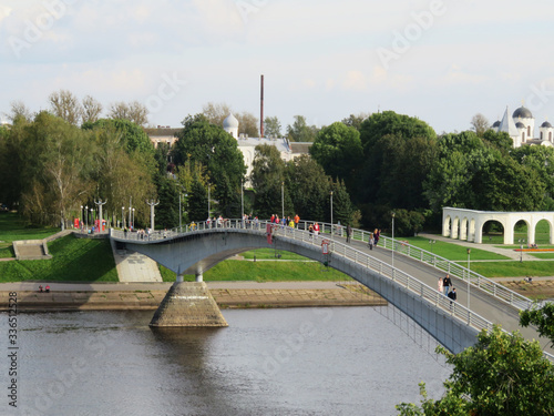 Russia. Veliky Novgorod. Shopping malls are the second center in Veliky Novgorod. Yaroslav's court.  A humpback pedestrian bridge leads from the Kremlin to the Shopping side . photo