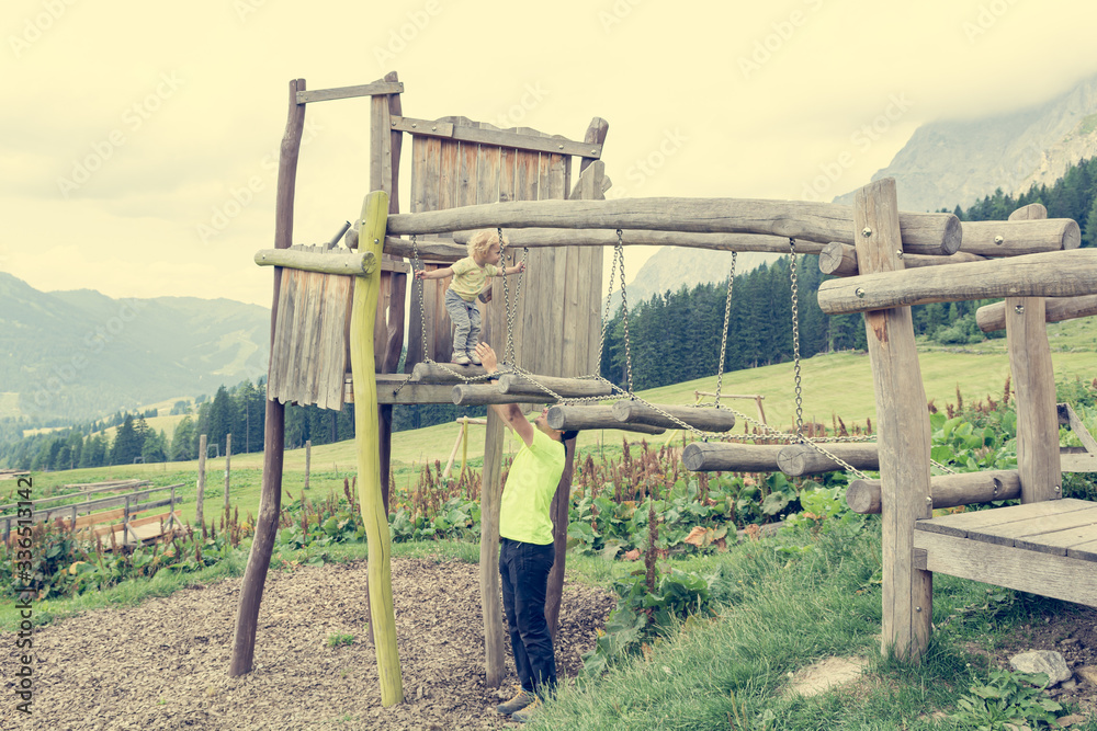 Father and daughter playing and climbing at outdoor playground. Father and daughter playing and climbing at outdoor playground.