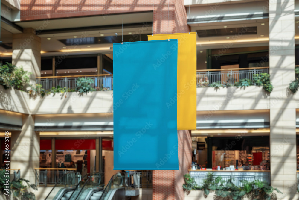 Two empty clean banners hanged inside the shopping mall. Copy space for promo text or logo promotion