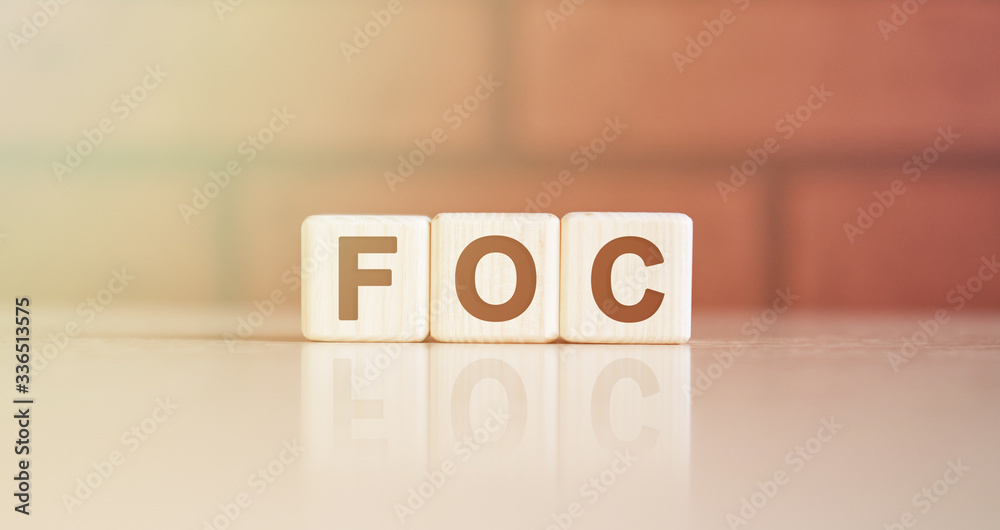FOC acronym concept. Text on wooden cubes with bright light