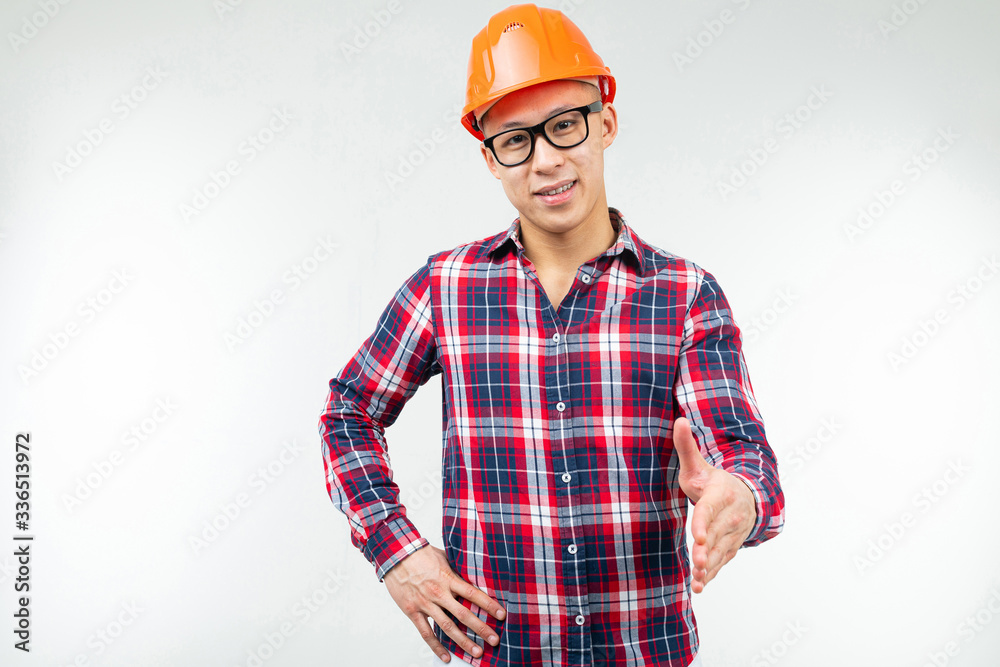 man in glasses with an orange helmet for safety on a white background