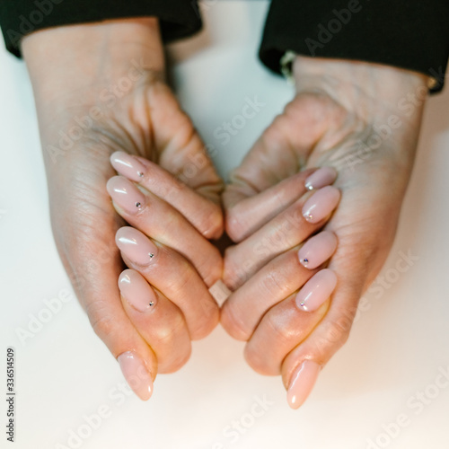 Woman's hand with pink nails