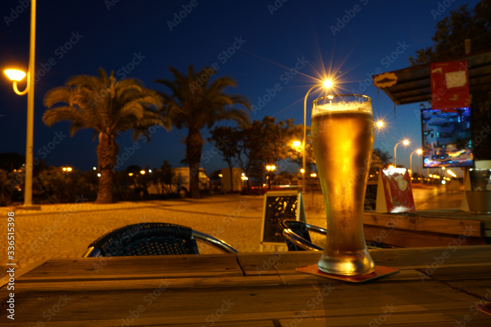 night view of the city street and a glas of beer