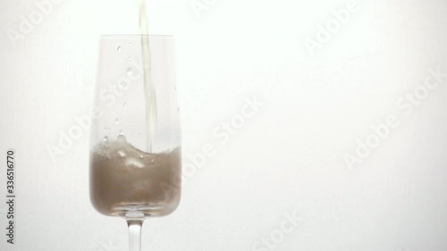 pours champagne into a glass close-up