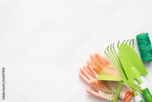 Gardening equipment and accessories on white wooden table background.