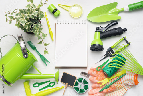 Garden to do list template. Gardening equipment and accessories on white wooden table background. photo