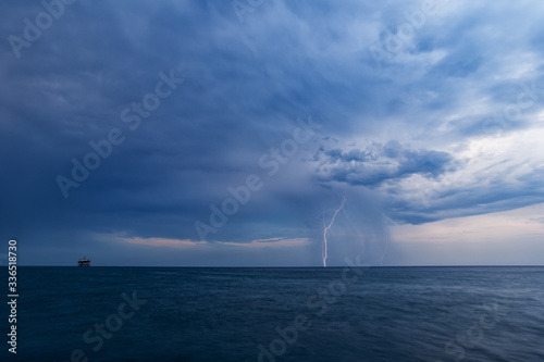 Daytime lightning with rain and dark clouds over the Black sea