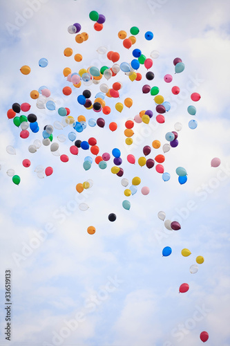 Many multicolored air balloons are flying in the sky