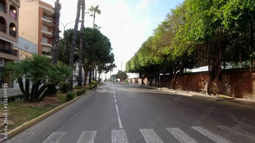 Torrevieja, Spain - March 30, 2020: Empty urban road, no cars land vehicles due to quarantine period caused by corona virus pandemic outbreak. Torrevieja, Alicante province Costa Blanca, Spain Torrevieja, Spain - March 30, 2020: Empty urban road, no cars land vehicles due to quarantine period caused by corona virus pandemic outbreak. Torrevieja, Alicante province Costa Blanca, Spain