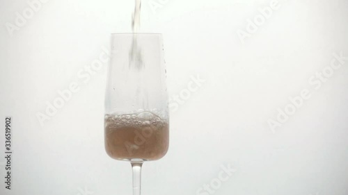 pours champagne into a glass close-up