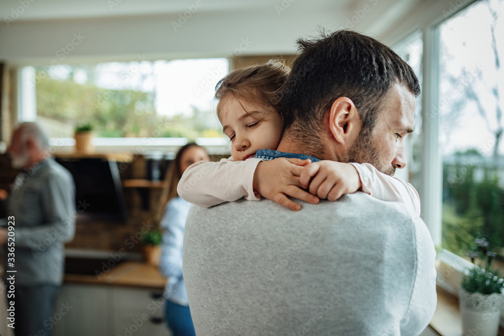 Affectionate daughter embracing her father with eyes closed. Affectionate daughter embracing her father with eyes closed.