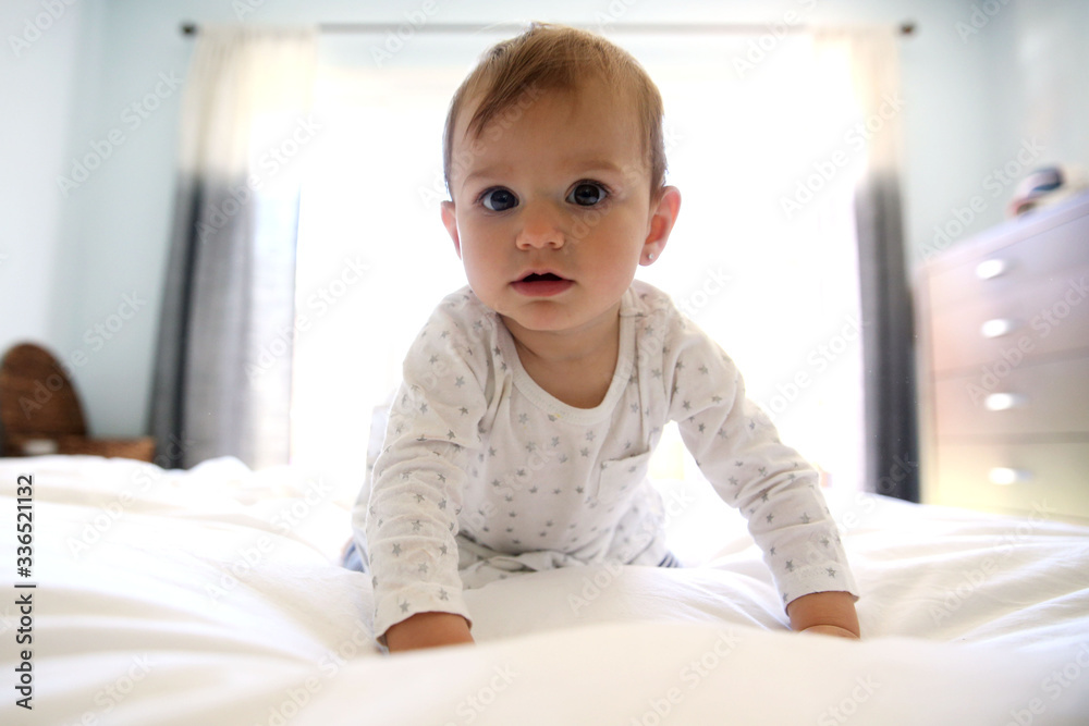 girl on bed with lights from window behind girl on bed with lights from window behind