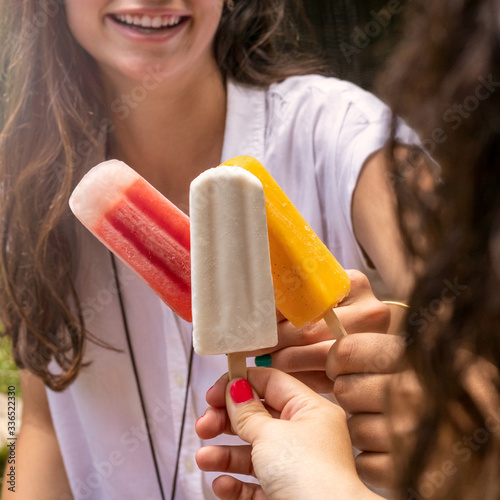Photos Young woman eating ice cream
