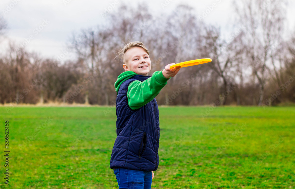 Teenager playing frisbee in the park