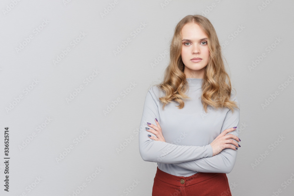 Half-length portrait of a girl with arms crossed