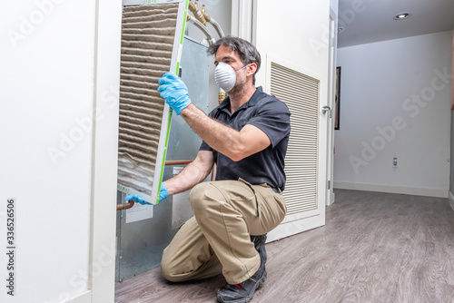 HVAC Worker Removing Air Filter