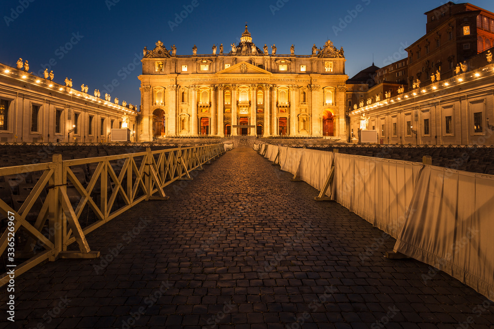Peaceful blue hour in Saint Peter's Square facing Saint Peter's Basilica with no people.