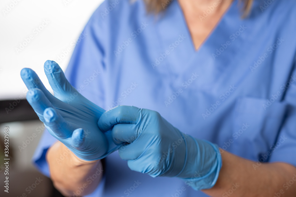 nurse taking off protective globes. Shallow focus on globes nurse taking off protective globes. Shallow focus on globes